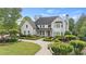 Stunning two-story home featuring manicured landscaping and a circular driveway at 9315 Prestwick Club Dr, Johns Creek, GA 30097