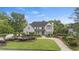 Beautiful two-story home with lush green lawn and meticulous landscaping at 9315 Prestwick Club Dr, Johns Creek, GA 30097
