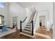 Inviting foyer with staircase, wood floors, and stylish decor at 9315 Prestwick Club Dr, Johns Creek, GA 30097