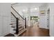 Bright foyer features hardwood floors, staircase, and an open view to the living room with skylights at 9315 Prestwick Club Dr, Johns Creek, GA 30097