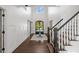 Elegant home foyer with soaring ceilings, chandelier, wood floors, and staircase at 9315 Prestwick Club Dr, Johns Creek, GA 30097