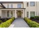 Elegant front entrance showcasing stone walkway, manicured bushes and arched double doors at 9315 Prestwick Club Dr, Johns Creek, GA 30097