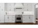 Modern kitchen featuring white cabinets, stainless steel oven, and a subway tile backsplash at 9315 Prestwick Club Dr, Johns Creek, GA 30097