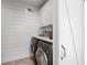 Well-equipped laundry room featuring a washer, dryer, and storage at 9315 Prestwick Club Dr, Johns Creek, GA 30097