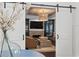 Open living room with barn doors, accent ceiling and a cozy fireplace at 9315 Prestwick Club Dr, Johns Creek, GA 30097