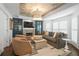 Inviting living room with a coffered ceiling, built-in shelving, and a modern color palette at 9315 Prestwick Club Dr, Johns Creek, GA 30097