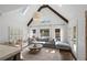 Bright living room with vaulted ceilings, exposed beams, and a comfortable seating area overlooking the backyard at 9315 Prestwick Club Dr, Johns Creek, GA 30097