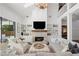 Cozy living room with fireplace, built-ins, and natural light from large windows at 9315 Prestwick Club Dr, Johns Creek, GA 30097