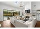 Spacious living room with a fireplace, built-in shelves, and a view of the backyard pool area at 9315 Prestwick Club Dr, Johns Creek, GA 30097