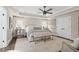Serene primary bedroom featuring a tray ceiling, neutral tones, and an abundance of natural light at 9315 Prestwick Club Dr, Johns Creek, GA 30097