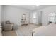 Airy bedroom with stylish rug, vanity area, and light-filled staircase landing at 9315 Prestwick Club Dr, Johns Creek, GA 30097