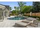 Serene pool area with lounge chairs, mature trees, and a partially fenced perimeter at 9315 Prestwick Club Dr, Johns Creek, GA 30097