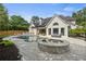 Beautiful pool area featuring a spa, outdoor kitchen, and lounge seating, ideal for relaxation at 9315 Prestwick Club Dr, Johns Creek, GA 30097