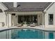 Luxurious pool area with outdoor seating and seamless indoor-outdoor living at 9315 Prestwick Club Dr, Johns Creek, GA 30097