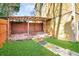 Fenced backyard with artificial grass, brick patio, and access to the house at 1093 Third St, Stone Mountain, GA 30083