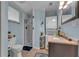 Bathroom with white shower, blue walls, stacked washer/dryer, granite vanity, and toilet at 1093 Third St, Stone Mountain, GA 30083