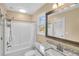 Bathroom featuring a tub, shower, granite countertop vanity and framed mirror adding a touch of elegance at 1093 Third St, Stone Mountain, GA 30083