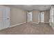Spacious bedroom featuring carpeted floors, neutral walls, and multiple doors for closet and hallway access at 1093 Third St, Stone Mountain, GA 30083