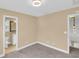 Cozy bedroom featuring neutral walls and carpet, with an en-suite bathroom, and ample natural light at 1093 Third St, Stone Mountain, GA 30083