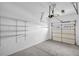Attached garage with overhead door, shelving, and sealed concrete floors at 1093 Third St, Stone Mountain, GA 30083