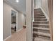Hallway leading to a bedroom with wood-look floors and a carpeted staircase with natural lighting at 1093 Third St, Stone Mountain, GA 30083