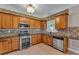 Modern kitchen featuring stainless steel appliances, granite countertops, ample cabinet space, and modern backsplash at 1093 Third St, Stone Mountain, GA 30083