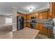 Stylish kitchen with stainless steel appliances, granite countertops, and mosaic backsplash, seamlessly connected to the living area at 1093 Third St, Stone Mountain, GA 30083