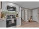 Modern kitchen featuring stainless steel appliances, granite countertops, and access to living spaces at 1093 Third St, Stone Mountain, GA 30083