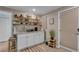 Kitchenette with white cabinets, open shelving, granite countertops, and stylish decor, creating a modern space at 1093 Third St, Stone Mountain, GA 30083
