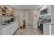 Well-equipped kitchenette with stainless steel appliances, granite countertops, open shelves, and modern design at 1093 Third St, Stone Mountain, GA 30083