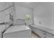 Functional laundry room offers shelving for organization, a window for natural light, and updated appliances at 1093 Third St, Stone Mountain, GA 30083