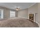 Spacious living room featuring plush carpeting, a cozy fireplace, and a large window for ample natural light at 1093 Third St, Stone Mountain, GA 30083