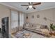 Cozy living room featuring a comfortable couch, decorative pillows, a glass table, and ample natural light at 1093 Third St, Stone Mountain, GA 30083