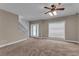 Bright living room featuring a staircase, a large window, and a glass front door leading to outdoor light at 1093 Third St, Stone Mountain, GA 30083