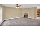 Open living area with fireplace, ceiling fan and view of the kitchen with stainless appliances and breakfast bar at 1093 Third St, Stone Mountain, GA 30083