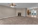 Cozy living room with a charming fireplace and an open view leading to the kitchen with stainless steel appliances at 1093 Third St, Stone Mountain, GA 30083