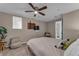 Main bedroom featuring a plush bed, ceiling fan, carpet, a sitting chair, and bathroom access at 1093 Third St, Stone Mountain, GA 30083