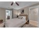 Main bedroom featuring a plush bed, ceiling fan, carpet, and bathroom access at 1093 Third St, Stone Mountain, GA 30083