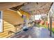 Cozy outdoor patio area with corrugated metal awning, bistro lights, prep sink, and access to the backyard at 1093 Third St, Stone Mountain, GA 30083