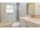Modern bathroom featuring gray tiling, a glass shower door, and a vanity with mirror at 269 Moreland Way, Atlanta, GA 30354
