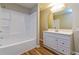Well-lit bathroom with a shower-tub combination, storage shelves and modern vanity at 269 Moreland Way, Atlanta, GA 30354