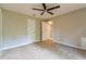 This bedroom features neutral walls and carpet, with a ceiling fan for added comfort at 269 Moreland Way, Atlanta, GA 30354