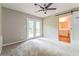 Bedroom with natural light, carpet floors, and barn door entry to bathroom at 269 Moreland Way, Atlanta, GA 30354
