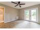 Bright bedroom features a ceiling fan and double doors to a wooden deck at 269 Moreland Way, Atlanta, GA 30354