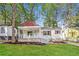 Inviting home featuring a covered porch, well-maintained lawn, and classic architectural details at 269 Moreland Way, Atlanta, GA 30354