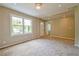Bright living room featuring plush carpet, a large window, and neutral paint at 269 Moreland Way, Atlanta, GA 30354