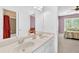 En-suite bathroom features double sinks and a large mirror, adjoining the main bedroom at 3120 Abbey Sw Dr, Atlanta, GA 30331