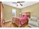 Comfortable bedroom with a wooden bed frame, wood floors and a chair at 3120 Abbey Sw Dr, Atlanta, GA 30331