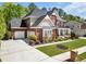 Attractive brick home features a double garage, manicured lawn, and traditional architectural details at 3120 Abbey Sw Dr, Atlanta, GA 30331
