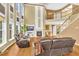 Spacious living room featuring large windows, hardwood floors, fireplace, and staircase access at 3120 Abbey Sw Dr, Atlanta, GA 30331